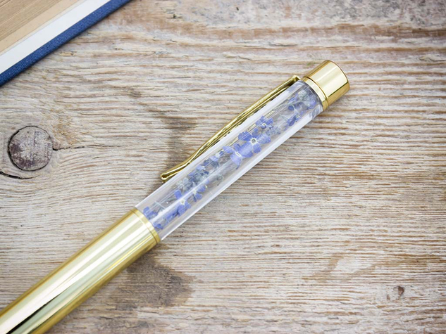 Kék nefelejccsel díszített arany színű toll